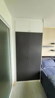a room with a closet and a bed and a door at Plus condominium 2 kathu in Kathu