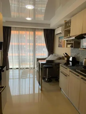 a kitchen with a desk and a bed in a room at Nai Harn NBC 1 BR in Rawai Beach