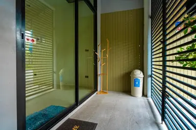 a bathroom with a shower with a glass door at Ellie House Phuket Old Town in Ban Rangeng