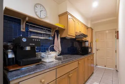 a kitchen with a sink and a clock on the wall at 1 bed condo, No.1 location, next to Patong Beach. in Patong Beach