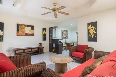 a living room with couches and a ceiling fan at 1 bed condo, No.1 location, next to Patong Beach. in Patong Beach