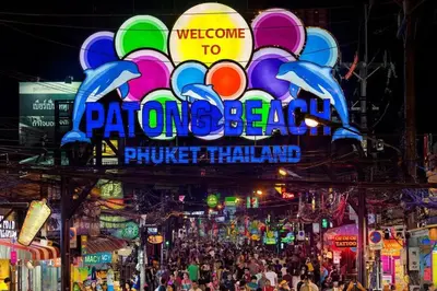 a crowd of people walking in a street at night at 1 bed condo, No.1 location, next to Patong Beach. in Patong Beach
