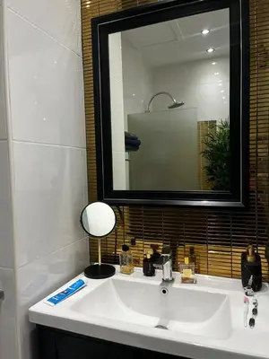 a bathroom with a white sink and a mirror at New 1 bed condo, very best central area, Patong in Patong Beach