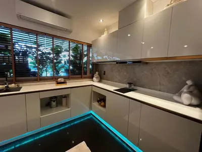 a kitchen with a swimming pool in the middle at New 1 bed condo, very best central area, Patong in Patong Beach