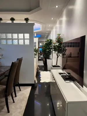 a dining room with a counter and chairs and a table at New 1 bed condo, very best central area, Patong in Patong Beach