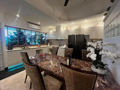 a kitchen with a table with chairs and a refrigerator at New 1 bed condo, very best central area, Patong in Patong Beach