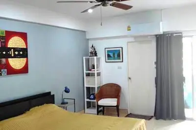 a bedroom with a bed and a ceiling fan at DAO Studio Apartments in Patong Beach
