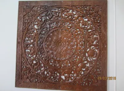 a wooden wall art with a circular design on it at DAO Studio Apartments in Patong Beach