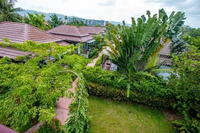 an aerial view of a house with trees and plants at Himaphan Boutique Resort - SHA EXTRA PLUS in Nai Yang Beach
