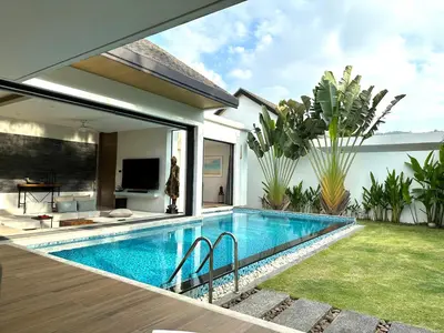 a swimming pool in the backyard of a house at Villa Amata in Phuket Town