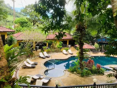 a resort with a swimming pool and lounge chairs at patong beautiful pool villa in Patong Beach