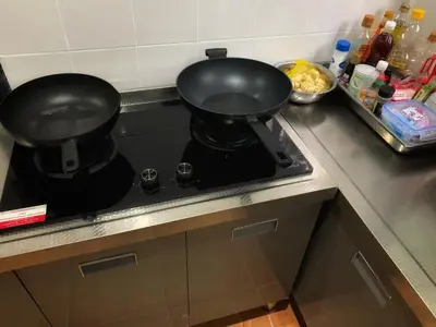 two pans sitting on top of a stove in a kitchen at patong beautiful pool villa in Patong Beach