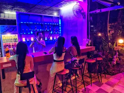 a group of girls sitting at a bar at patong beautiful pool villa in Patong Beach