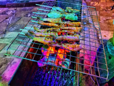 a bunch of food cooking on a grill at patong beautiful pool villa in Patong Beach