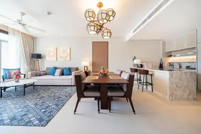 a kitchen and a living room with a table and chairs at Apartment in the center of Laguna with lake view in Bang Tao Beach
