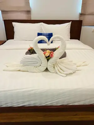 two swans made out of towels on a bed at Aonang Peace Pool Villa in Ban Khlong Haeng