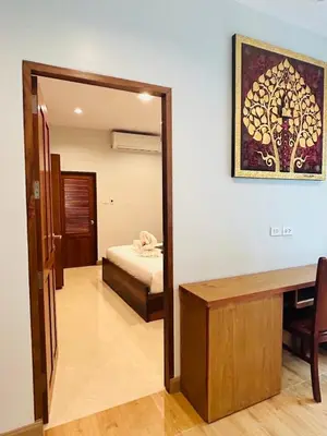 a room with a bedroom with a bed and a mirror at Aonang Peace Pool Villa in Ban Khlong Haeng