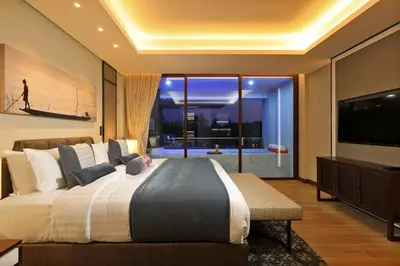 a bedroom with a large bed and a television at 2bdr Lakeview Apartment Angsana oceanview residence by Capital Pro in Bang Tao Beach