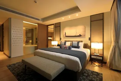 a bedroom with a large bed and two lamps at 2bdr Lakeview Apartment Angsana oceanview residence by Capital Pro in Bang Tao Beach