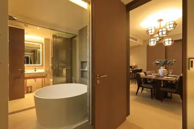 a bathroom with a tub and a dining room with a table at 2bdr Lakeview Apartment Angsana oceanview residence by Capital Pro in Bang Tao Beach
