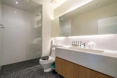 a bathroom with a toilet and a sink and a mirror at Studio with forest view - Zen Space by Lofty in Kamala Beach