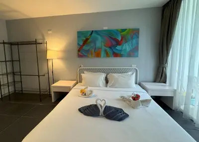 a bedroom with a white bed with two towels on it at Studio with forest view - Zen Space by Lofty in Kamala Beach