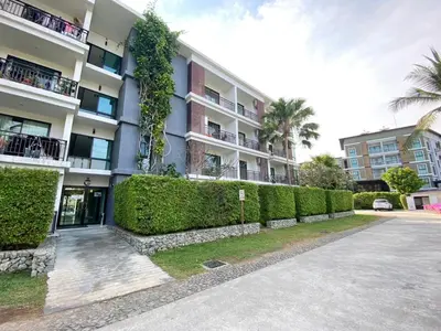 an apartment building with a hedge in front of it at Rawai - Beachfront Apartement - The Title in Rawai Beach