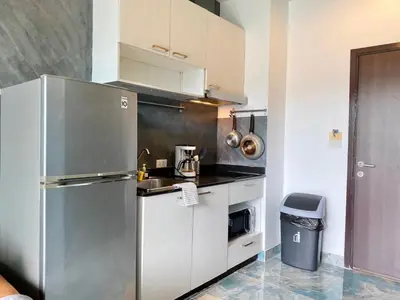 a kitchen with a stainless steel refrigerator and a sink at Rawai - Beachfront Apartement - The Title in Rawai Beach