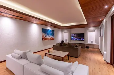 a living room with a white couch and a table at Villa La Thale in Phuket Town