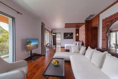 a living room with white couches and a tv at Villa La Thale in Phuket Town