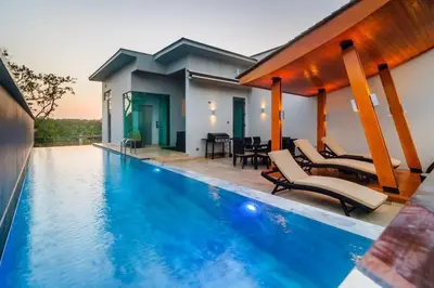 a villa with a swimming pool and a house at EVA Beach sea view Four room villa in Ban Saiyuan (1)