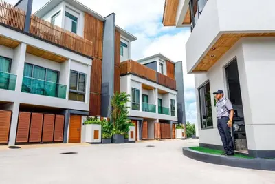 a man standing on the side of a building at EVA Beach sea view Four room villa in Ban Saiyuan (1)