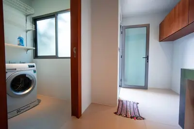 a laundry room with a washing machine and a window at EVA Beach sea view Four room villa in Ban Saiyuan (1)