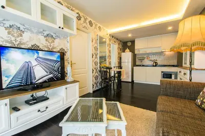 a living room with a large flat screen tv at The Title Boutique Phuket in Rawai Beach