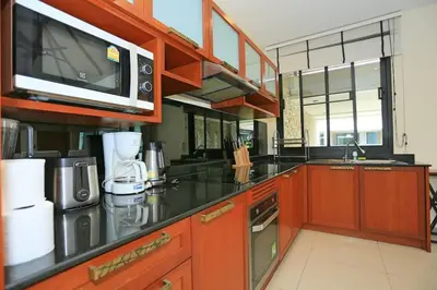 a kitchen with a microwave and a counter top at Rawai VIP 2D2 Tow-bedroom villa in Phuket Town