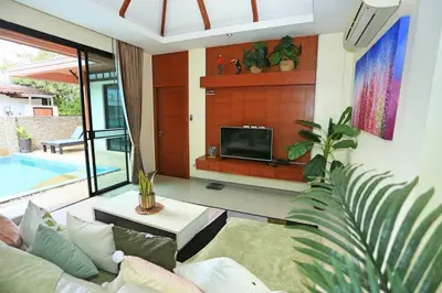 a living room with a couch and a tv at Rawai VIP 2D2 Tow-bedroom villa in Phuket Town