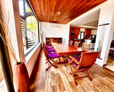 a dining room with a wooden table and chairs at Coconut Palms Villa, Large & Elegant Private Pool Villa in Rawai, Phuket in Ban Saiyuan (1)