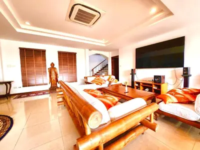 a living room with two couches and a table at Coconut Palms Villa, Large & Elegant Private Pool Villa in Rawai, Phuket in Ban Saiyuan (1)