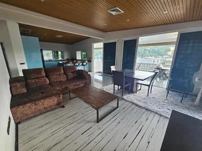a living room with a couch and a table at Castle Villa Phuket in Kamala Beach