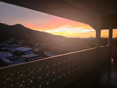 a view of a sunset from a balcony at Castle Villa Phuket in Kamala Beach