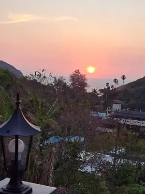 a view of the sunset from a street light at Seaview Eagles Nest Cabins in Rawai Beach
