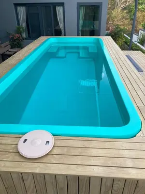 a blue swimming pool with a frisbee next to it at Seaview Eagles Nest Cabins in Rawai Beach