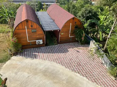 a large wooden house with a red roof at Seaview Eagles Nest Cabins in Rawai Beach