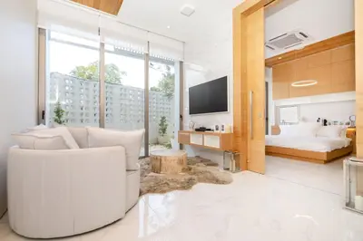 a living room with a white couch and a bed at Aesthetic 3 Storey Villa Residence A23, Private Pool, close to Ma Doo Bua Café and Laguna in Bang Tao Beach