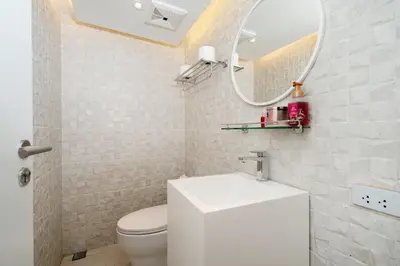 a bathroom with a white toilet and a mirror at Aesthetic 3 Storey Villa Residence A23, Private Pool, close to Ma Doo Bua Café and Laguna in Bang Tao Beach