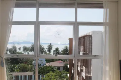 a window with a view of a city at Enjoy Krabi and Relax in Klong Muang Beach