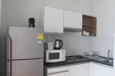 a kitchen with a white refrigerator and a microwave at Enjoy Krabi and Relax in Klong Muang Beach