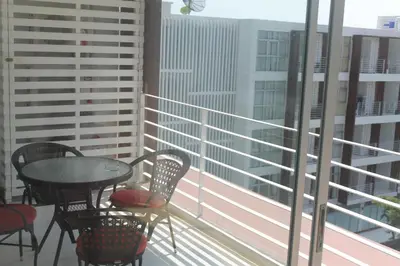 a balcony with a table and chairs on a balcony at Enjoy Krabi and Relax in Klong Muang Beach