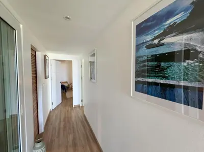 a hallway with a large painting on the wall at Boho chic sea view apartment in Kata in Kata Beach