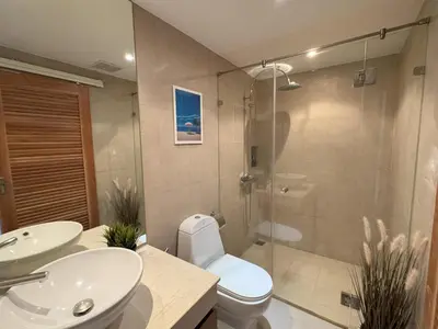 a bathroom with a toilet and a sink and a shower at Boho chic sea view apartment in Kata in Kata Beach